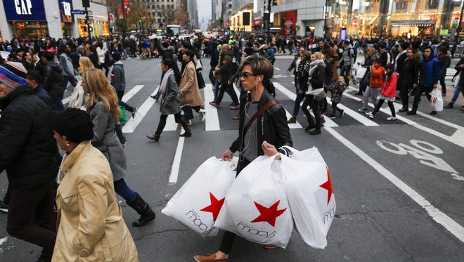 People carry retail shopping bags during Black Friday events on Nov. 25, 2016 in New York City.  The day after Thanksgiving, called Black Friday, is typically the biggest shopping day of the year in the United States.