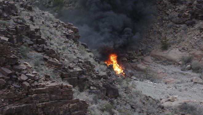 A crashed helicopter burns in a remote section of the Grand Canyon on Feb. 10, 2018.