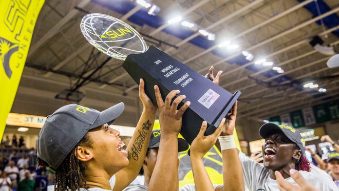 The FGCU women's basketball team celebrates winning the A-Sun Tournament championship against Jacksonville in Alico Arena on Sunday, March 11.