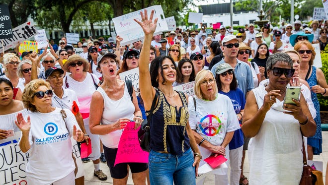 Protesters gather in front of the Collier County Courthouse in Naples on Saturday, June 30, 2018 to rally against the current immigration policies and to call for the reunification of families that were separated at Mexico's border.