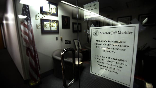 A sign is posted next to the door to the darkened offices of Sen. Jeff Merkley, D-Ore., in Portland, Ore., Wednesday, Oct. 2, 2013. The government shutdown is in its second day.(AP Photo/Don Ryan) ORG XMIT: ORDR101
