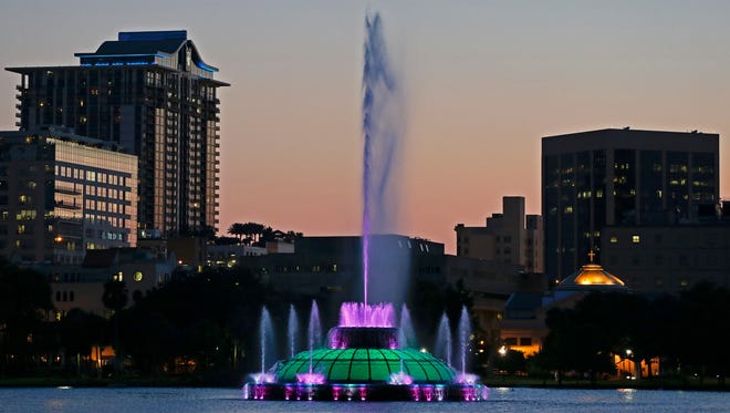 Water rises from a five-decade-old, green, multi-tiered fountain on Lake Eola that is the official icon of the city as the sun sets in Orlando, Fla on May 19, 2014.