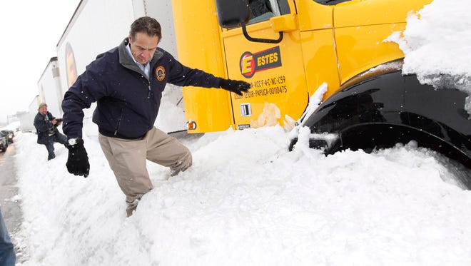 New York Gov. Andrew Cuomo checks on a snowbound trucker on the New York State Thruway in Cheektowaga, N.Y., on Wednesday, Nov. 19, 2014.