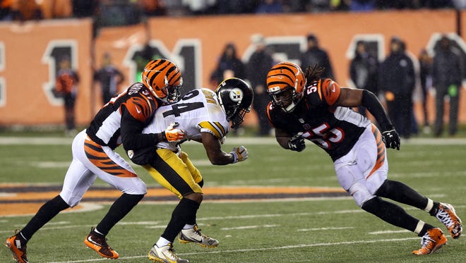 Jan 9, 2016; Cincinnati, OH, USA; Cincinnati Bengals outside linebacker Vontaze Burfict (55) hits Pittsburgh Steelers wide receiver Antonio Brown (84) during the fourth quarter in the AFC Wild Card playoff football game at Paul Brown Stadium. Burfict was called for a personal foul on the play.