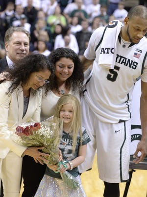 Tom Izzo, back left, and his wife Lupe and daughter Raquel stand with Lacey Holsworth during the senior day celebration for Adreian Payne (5) on March 6, 2014.