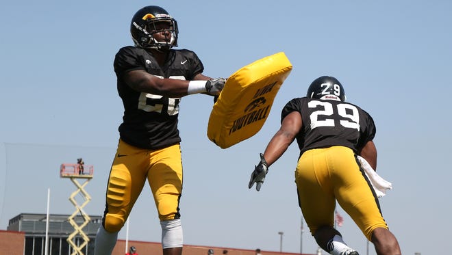 Iowa junior running back LeShun Daniels Jr., right, runs a drill during Saturday’s open practice at Valley Stadium. Daniels has 51 career carries for 191 yards but is showing he could be a primary option this fall.