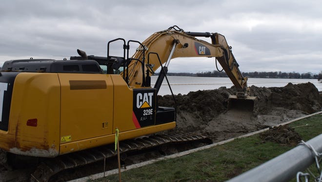 An excavator moves excess material as soil mixing continues on the  Buckeye Lake dam as new equipment was brought to the lake in late March.