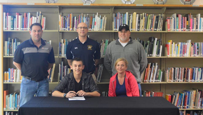 Owen Adams of Colonel Crawford signed to play football with Ohio Dominican University. Picture: Front Row (Left to Right): Owen Adams and Kelly Schafer; Back Row: Aaron Adams, Ryan Teglovic, Head Football Coach Colonel Crawford, and Kevin Schafer.