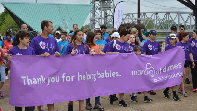 Families marched at the front of the line with a banner during the 2017 March of Dimes walk in Alexandria.