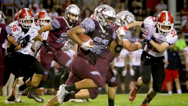 Menomonee Falls' Julius Davis breaks away from Sussex Hamilton defenders for a touchdown at home on Sept. 25.