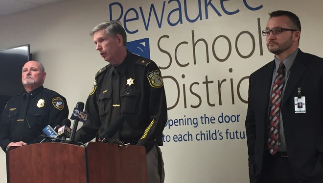 Pewaukee Police Chief Jay Iding (left), Waukesha County Sheriff Eric Severson (center) and Pewaukee School District Superintendent Mike Cady brief reporters March 14 at a press conference about a student threat that closed Pewaukee High School. The student is in police custody.