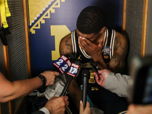 Michigan's Charles Matthews talks to the media in the