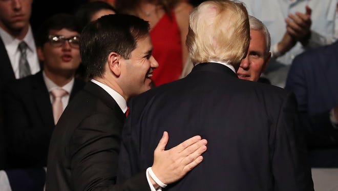 Sen. Marco Rubio walks with President Trump after he announced policy changes toward Cuba at the Manuel Artime Theater in the Little Havana neighborhood on June 16, 2017.