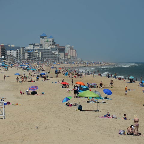 Umbrella's and crowds are starting to cover the...