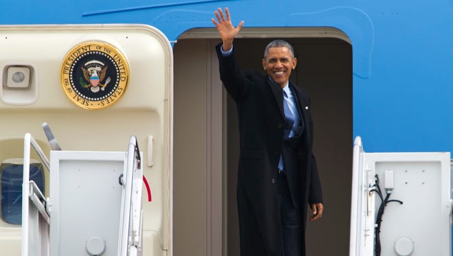President Obama waves as he boards Air Force One en route to Miami.