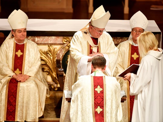 Archbishop of Louisville Joseph E. Kurtz puts his hands