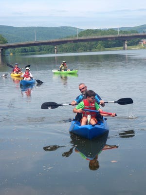 Paddlers float down the Chemung River.