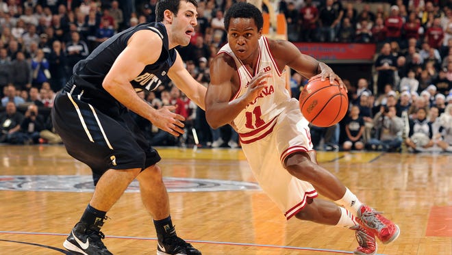 FILE -- IU's Yogi Ferrell, right, drives on Butler's Alex Barlow, left, in the 2012 Crossroads Classic game at Bankers Life Fieldhouse.