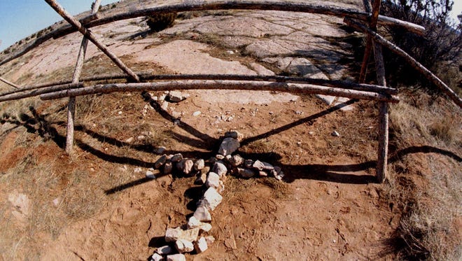 A stone cross lays near the spot where Matthew Shepard was found lashed to a buck fence on the high plains east of Laramie, Wyo.