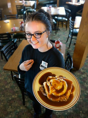 Server Miranda Bastien holds an order of the hot beef sandwich with whipped potatoes and gravy Tuesday, Feb. 23, a classic at The Copper Lantern in St. Cloud.