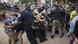 Officers clash with counter protestors after the Ku