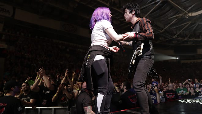 Green Day's Billie Joe Armstrong invited a fan to join him on vocals for the band's opening song, "Know Your Enemy," Thursday at the Resch Center. She finished her stint by stage diving into the sold-out crowd.