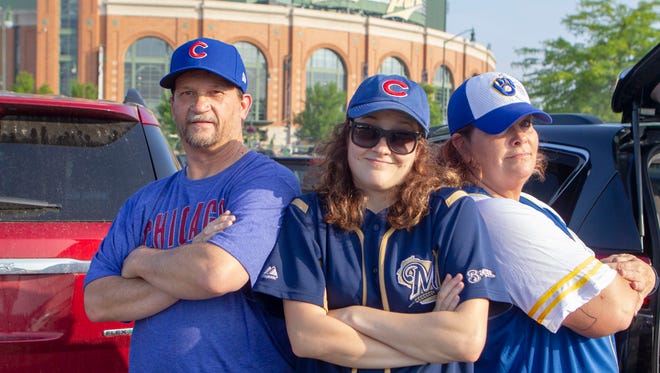 Bryon, Halie, and Tara Johnson (from left) of Janesville have a split family when it comes to their baseball allegiance. Bryon cannot give up the Cubbie blue, as he says he has been a Cubs fan since childhood.