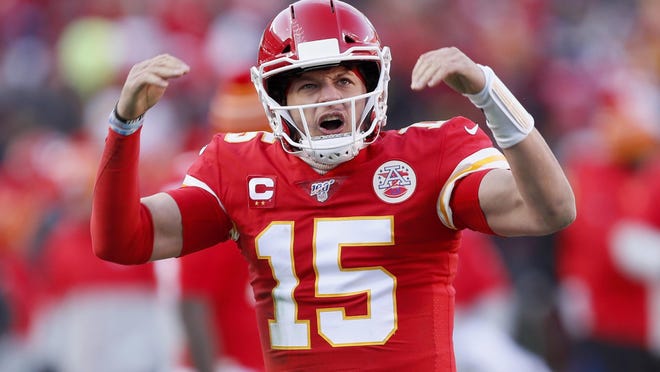 Chiefs' quarterback Patrick Mahomes reacts after throwing a touchdown pass to Tyreek Hill during the first half of the NFL AFC Championship football game.