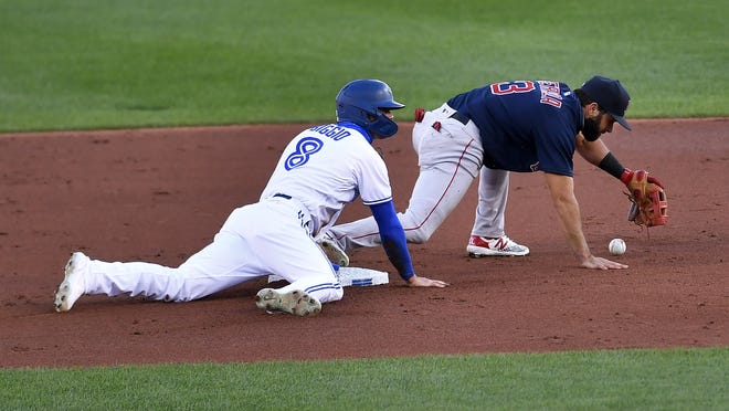 Boston Red Sox second baseman Jose Peraza (3) drops the ball as Toronto Blue Jays' Cavan Biggio (8) dives safely back to second base during the first inning of a baseball game in Buffalo, N.Y., Tuesday, Aug. 25, 2020. Boston beat Toronto 9-7.