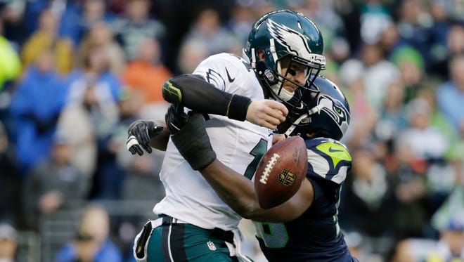 Philadelphia Eagles quarterback Carson Wentz fumbles as he is hit by Seattle Seahawks defensive end Cliff Avril in the second half of an NFL football game, Sunday, Nov. 20, 2016, in Seattle. The ball was recovered by the Eagles. (AP Photo/John Froschauer)