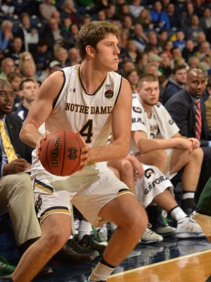 Notre Dame Fighting Irish guard Matt Ryan drives the lane around Chicago Cougars guard Anthony Eaves during action at Purcell Pavilion at the Joyce Center.