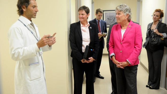 JUAN CARLO/THE STAR Dr. Neal Schwartz (left) talks with Ann Brown (middle), medical center director of VA Greater Los Angeles Healthcare System, and Rep. Julia Brownley (right) on Tuesday at an outpatient clinic for veterans in Oxnard. The clinic has been identified as one of the worst among clinics with backlogs for getting an appointment.