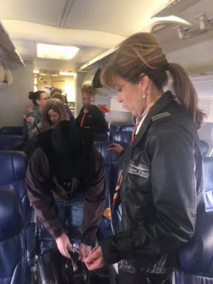 This photo provided by Diana McBride Self shows Flight 1380 pilot Tammie Jo Shults, right, interacting with passengers after an emergency landing of a Southwest plane on April 17, 2018.