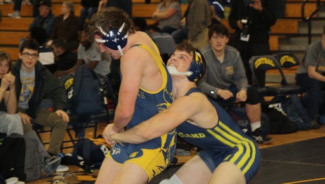 Hartland's Andrew Spisz won't let go of Walled Lake Central's Connor Merchant at 215 pounds on Wednesday, Feb. 15, 2017. Spisz won, 10-6.