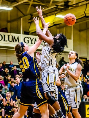 Gabby Iacobellis ,left, of DeWitt blocks a shot attempt by Maya Bennett of Waverly during their game Friday January 8, 2016 in Delta Township.  KEVIN W. FOWLER PHOTO