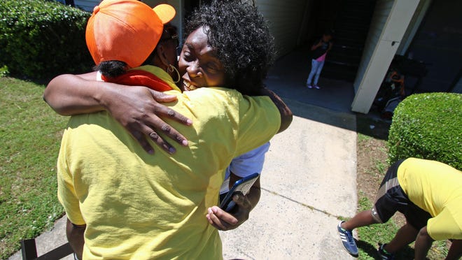 Thomasina Williams, right, gives a hug to Florence Eury after several vehicles from Risa's Special Delivery that were loaded with furniture and household items pulled into the parking lot of The Oaks apartment complex Saturday afternoon, May 9, 2020.