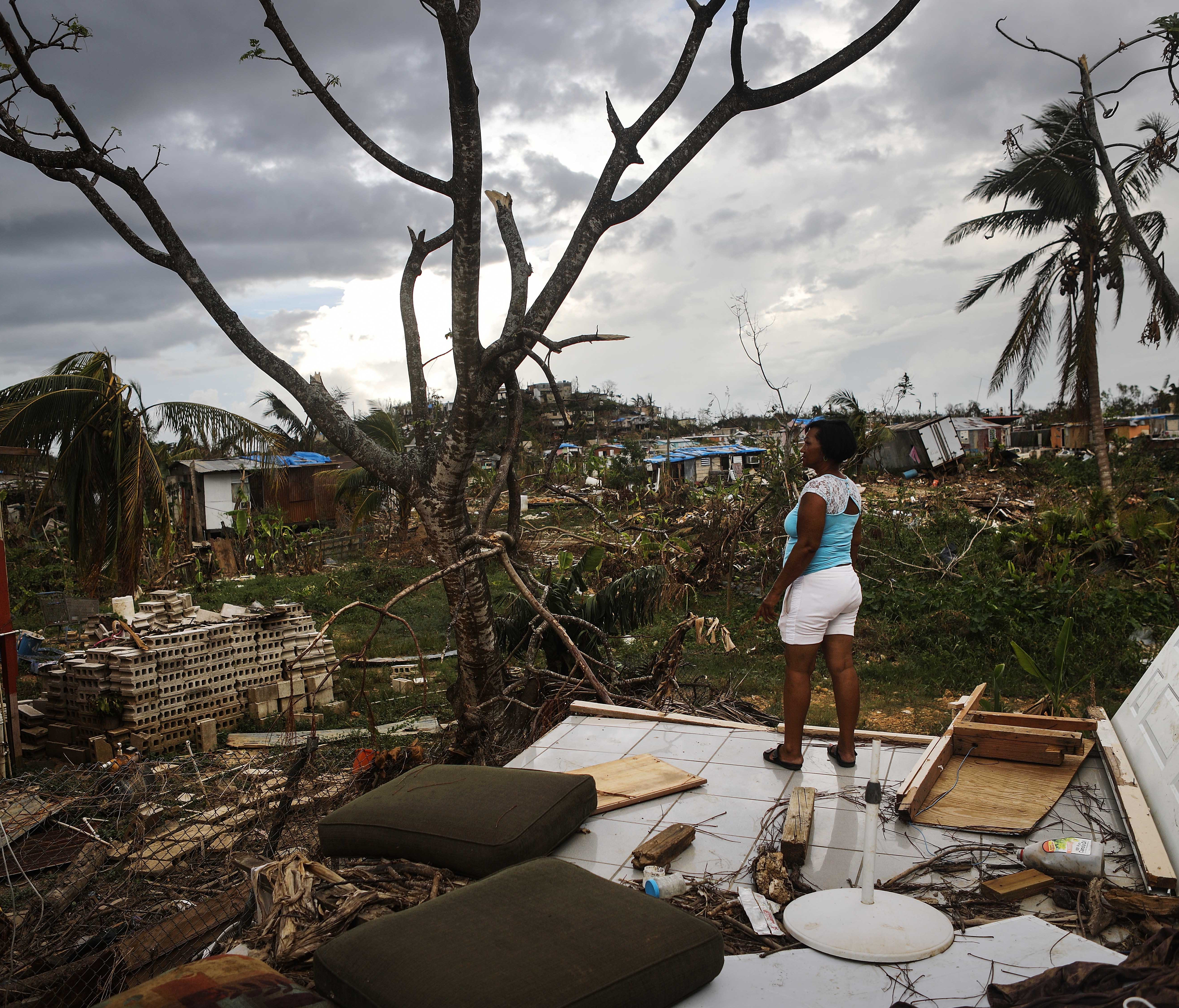 San Isidro, Puerto Rico resident Mirian Medina stands on her property on Oct. 5, 2017, about two weeks after Hurricane Maria swept through the island. Residents in her section of the town remain without grid power or running water.