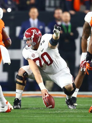 Alabama center Ryan Kelly plays against the Clemson Tigers in the 2016 CFP national championship game.