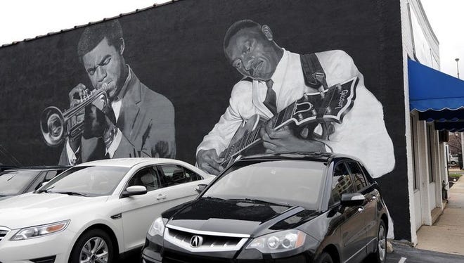 In this 2011 photo, a mural of Indianapolis jazz greats is still in progress on the side of the Musicians’ Repair & Sales shop, 332 N. Capitol Ave. Images of Freddie Hubbard, left, and Wes Montgomery are seen.