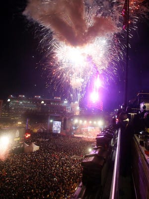 Fireworks and confetti fly through the air at midnight as thousands bring in 2015 at the Jack Daniel's Bash on Broadway.