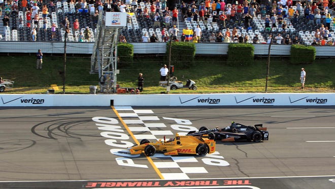Ryan Hunter-Reay (28) crosses the finish line to win the ABC Supply 500 at Pocono Raceway in 2015.