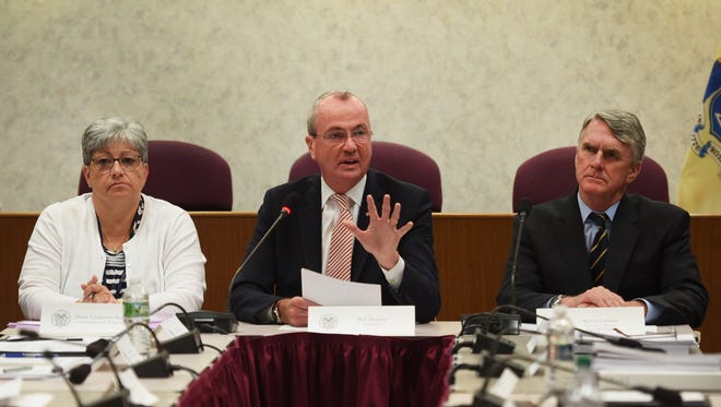 Gov. Phil Murphy speaks as Dianne Gutierrez-Scaccetti (L), Commissioner of Transportation, Kevin Corbett (R), Exec. Director of NJ Transit and senior staff members from NJ Transit Management, listen  during an NJ Transit briefing at the NJ Transit Headquarters in Newark on 08/09/18. This is his first public appearance since the agency experienced major delays and cancellations while he was on vacation.