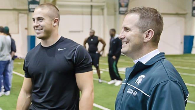 Michigan State linebackers coach Mike Tressel, right, looks on at NFL pro day in the Duffy Daugherty Football Building on March 16, 2011, in East Lansing.
