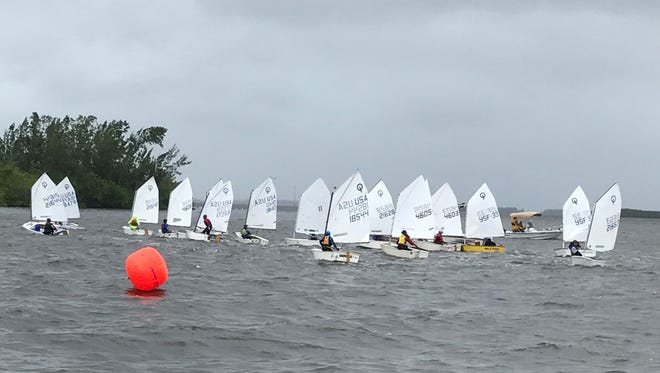 Twenty-two Optimist dinghies in two fleets, sailing a short triangle course near the launch area and partially protected by the 17th Street Bridge, got in four races despite the high winds and choppy water.