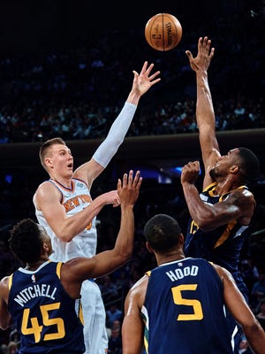 New York Knicks' Kristaps Porzingis, top left, shoots next to Utah Jazz's Derrick Favors, top right, during the first half of an NBA basketball game at Madison Square Garden in New York, Wednesday, Nov. 15, 2017.