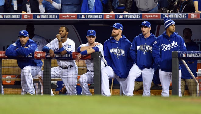 Royals players react from the dugout in the 9th inning.