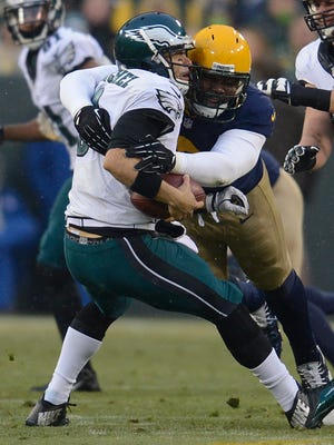 Green Bay Packers defensive tackle Letroy Guion sacks Philadelphia Eagles quarterback Mark Sanchez at Lambeau Field in November 2014.