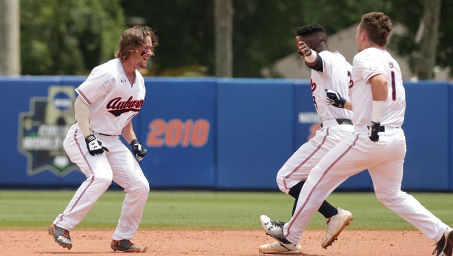Luke Jarvis (9) celebrates hitting a walk-off RBI single in the bottom of the 9th inning with teammates Josh Anthony (3) and Judd Ward (1). 
Auburn Tigers vs. Florida Gators in Game 2 of the Super Regional at Alfred A. McKethan Stadium in Gainesville, Fla. on Sunday, June 10, 2018.