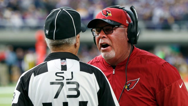 Arizona Cardinals head coach Bruce Arians, right, argues a call with side judge Joe Larrew during the first half of an NFL football game against the Minnesota Vikings Sunday, Nov. 20, 2016, in Minneapolis. Arians was in the hospital Monday after feeling ill overnight, the team said. The Cardinals issued a statement that said Arians was experiencing discomfort and not feeling well Sunday night after returning home from Arizona's game in Minnesota and his wife took him to the hospital. All tests conducted so far had come back favorably, the team said. (AP Photo/Jim Mone)