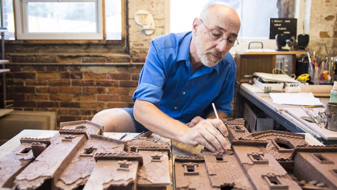 John Brickels works in his shared studio on Howard Street in the South End of Burlington, Aug. 23, in preparation for Art Hop.